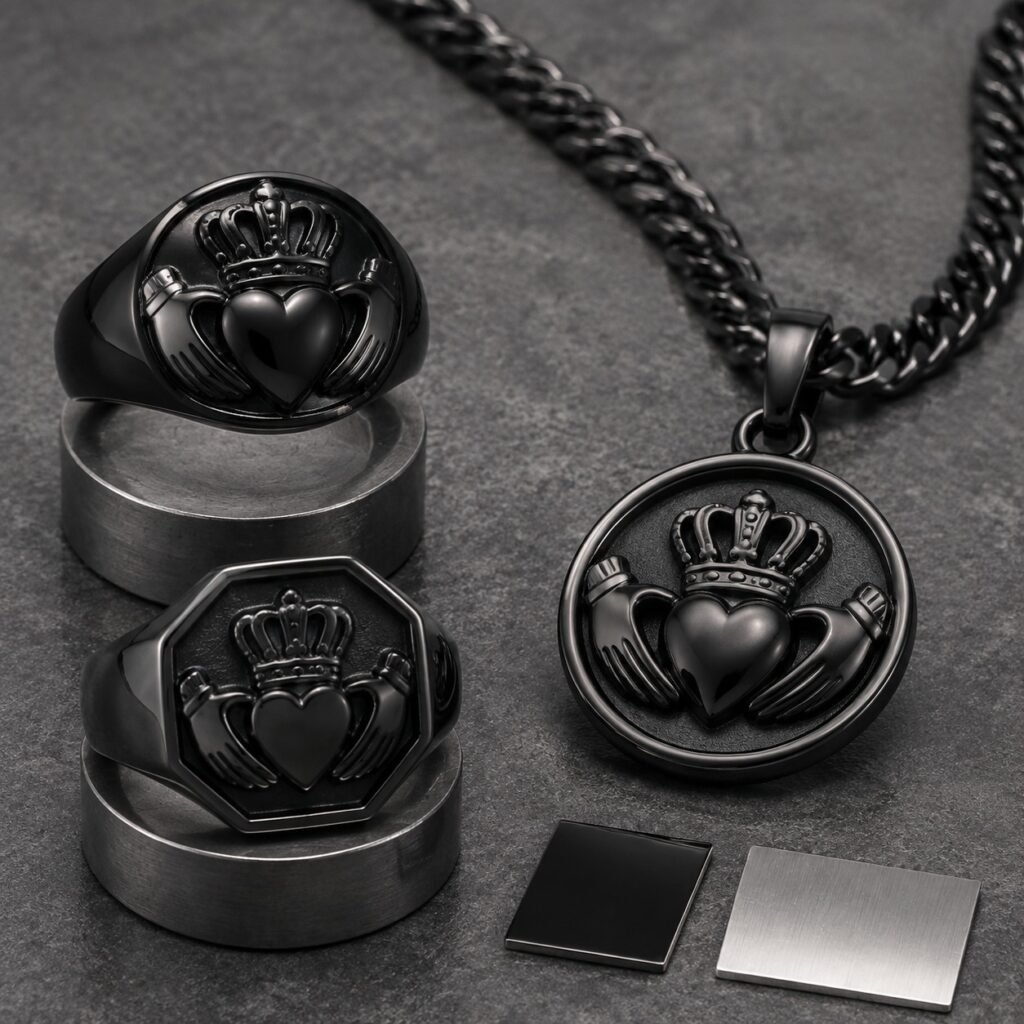 Men's black PVD Claddagh rings and pendant on a sample table