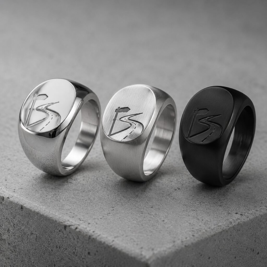 Three stainless steel road-marker signet rings in coordinated finishes